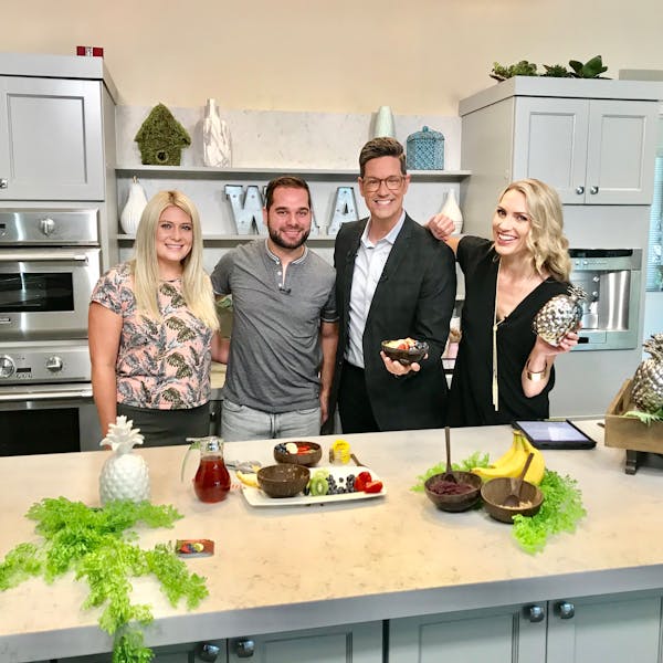 a group of people standing in a kitchen