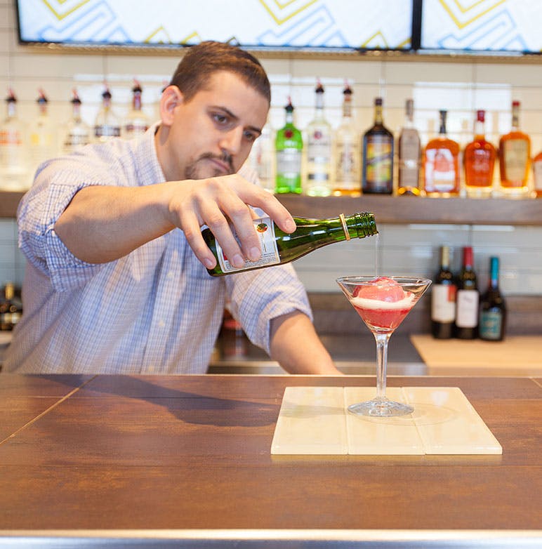 a person sitting at a table drinking wine