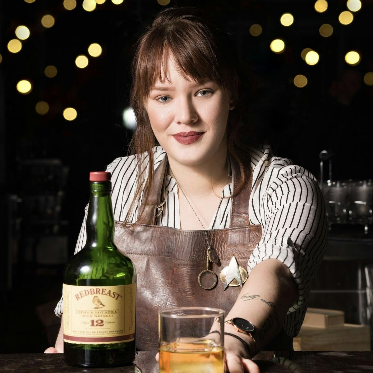 A woman serving a cocktail