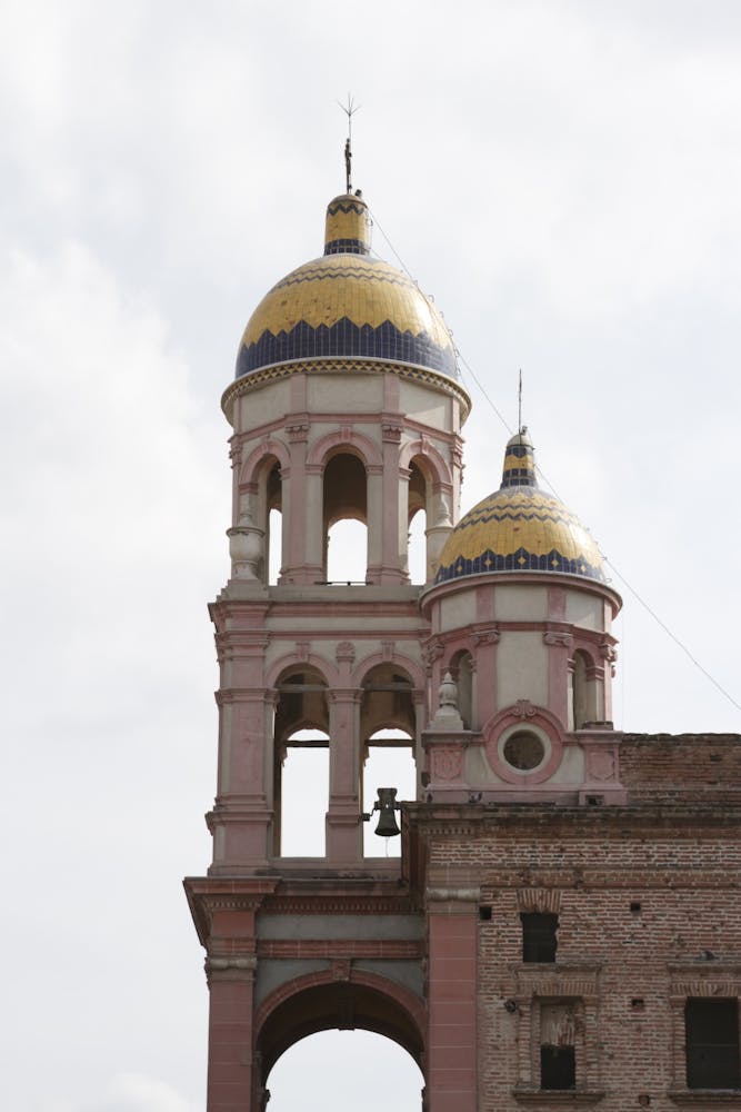 a large tall tower with a clock at the top of a building