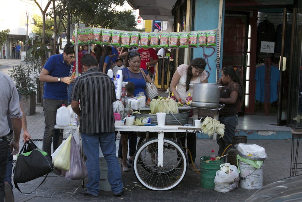 a group of people on a sidewalk