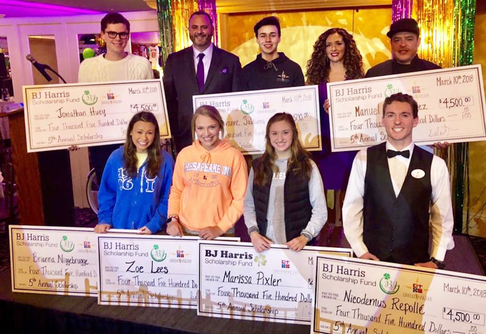 a group of people posing for a photo in front of a sign