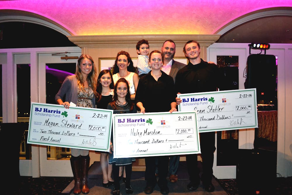a group of people standing in front of a sign