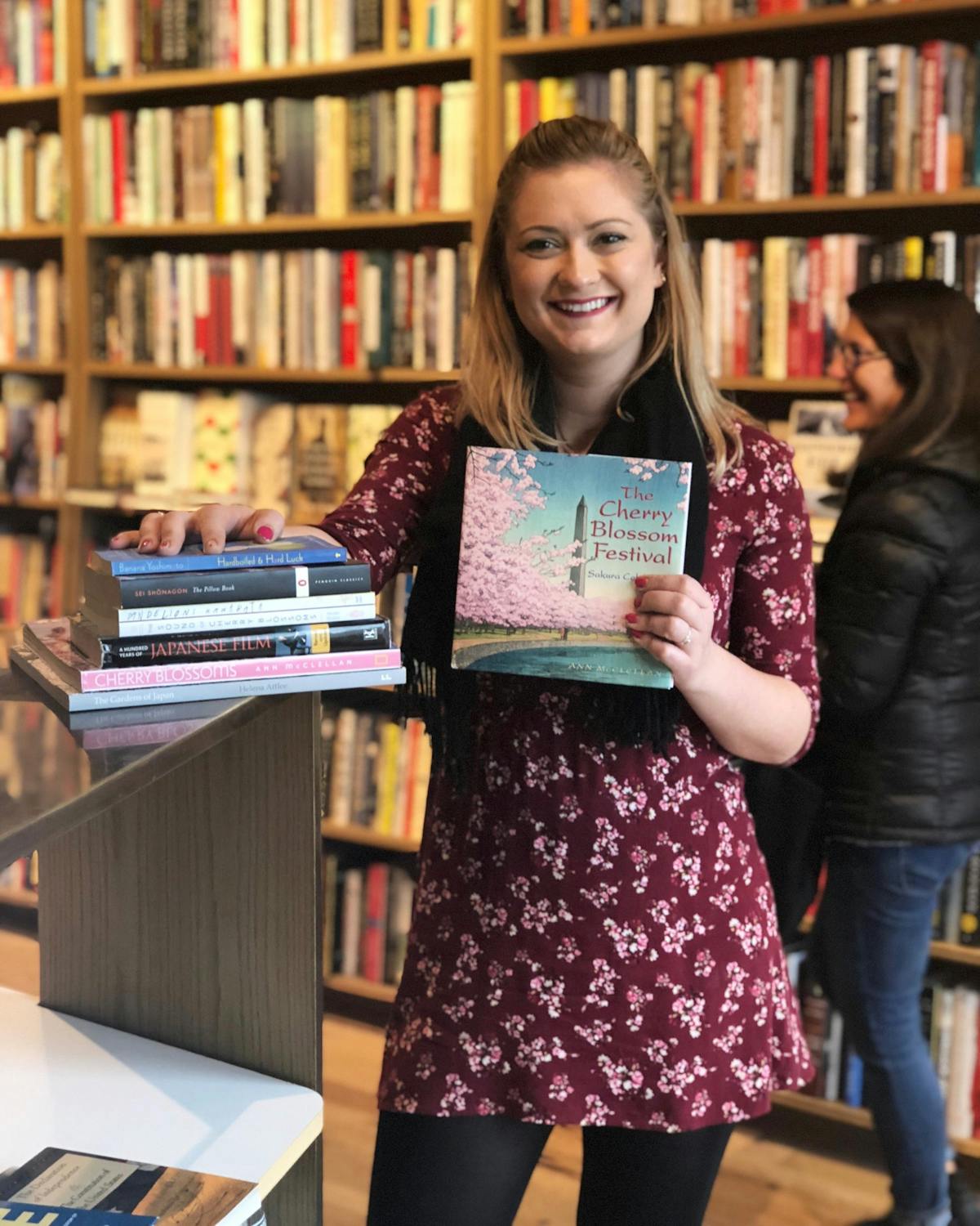 a woman reading a book shelf