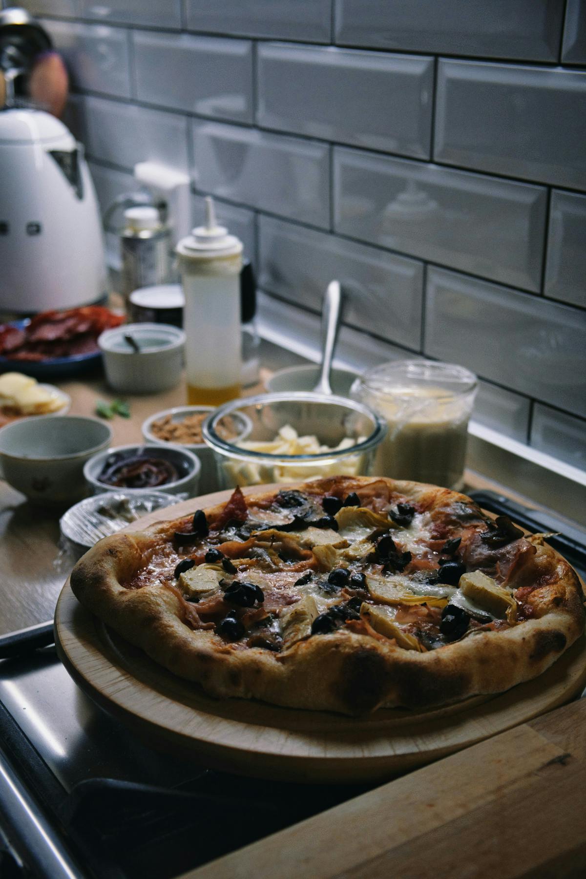a pizza sitting on top of a stove