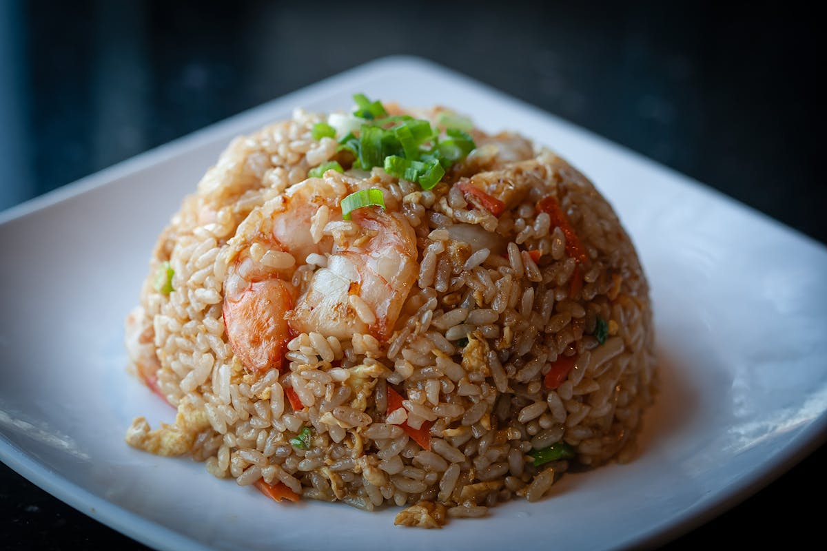 a plate of food with rice and broccoli