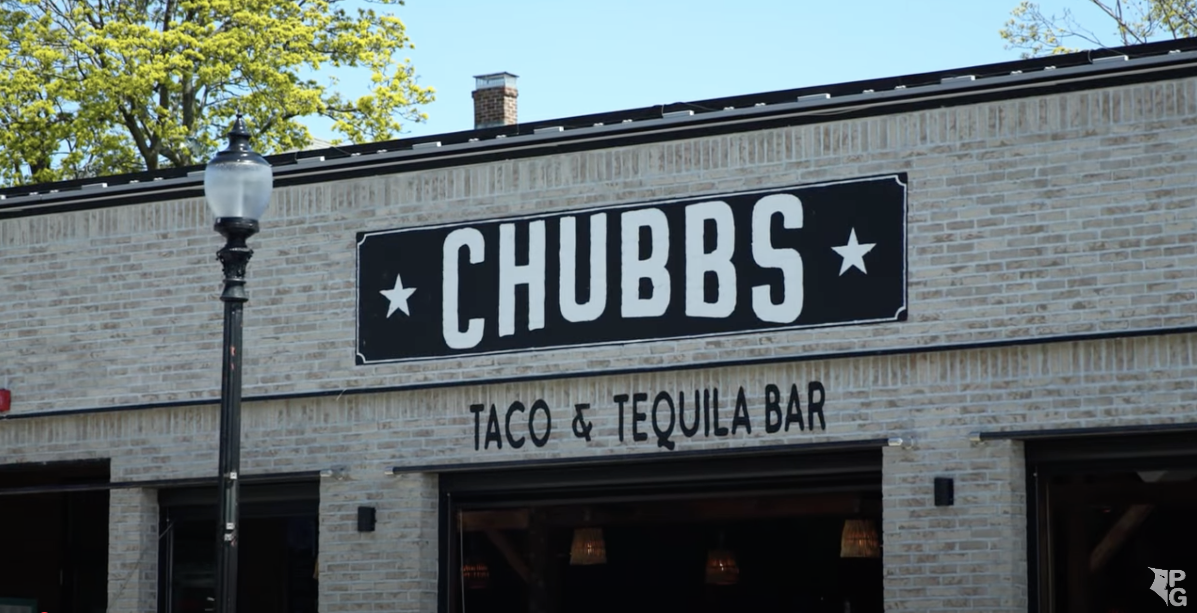 a sign in front of a brick building