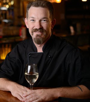 a man holding a glass of wine