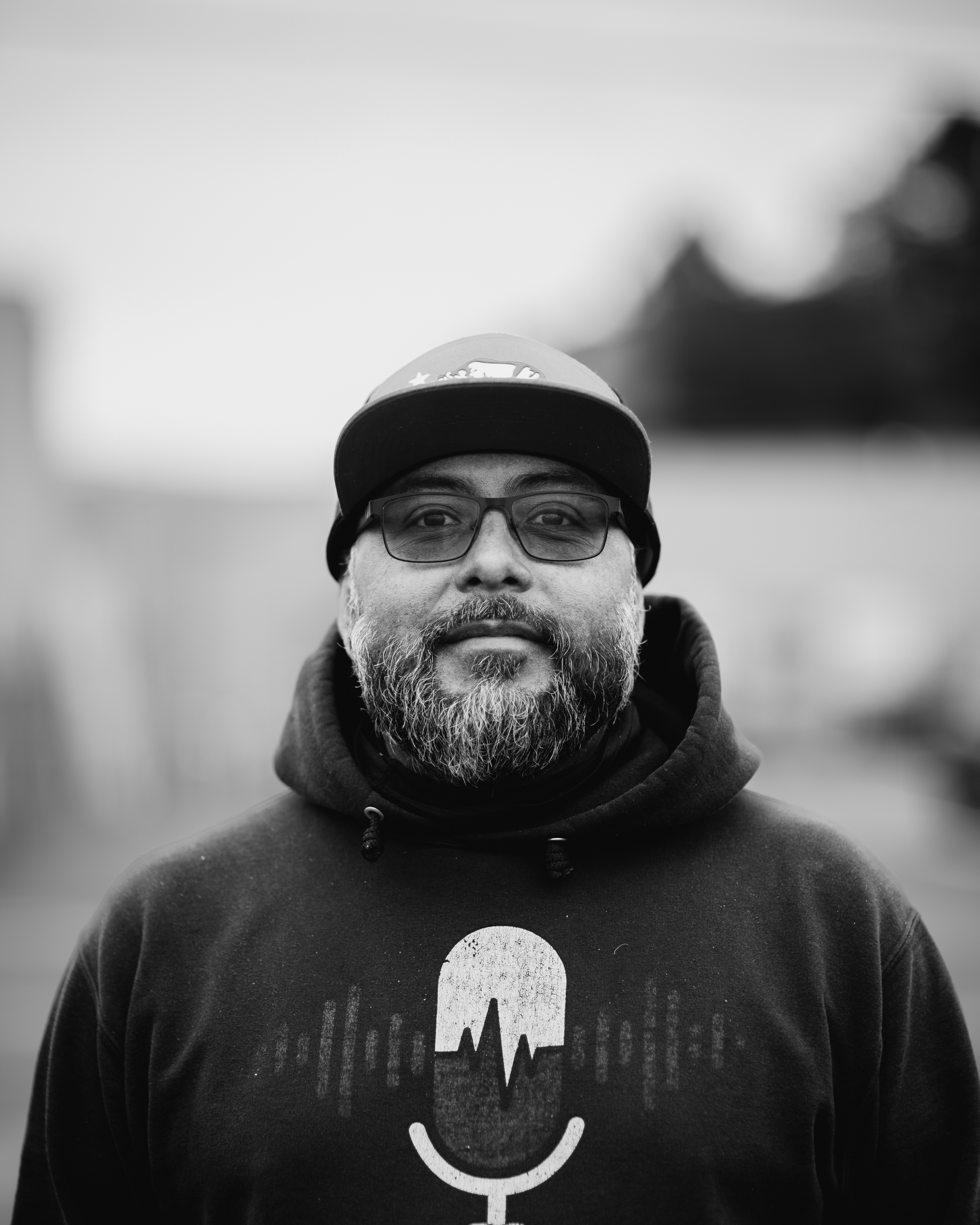 a man with a beard wearing a hat and glasses