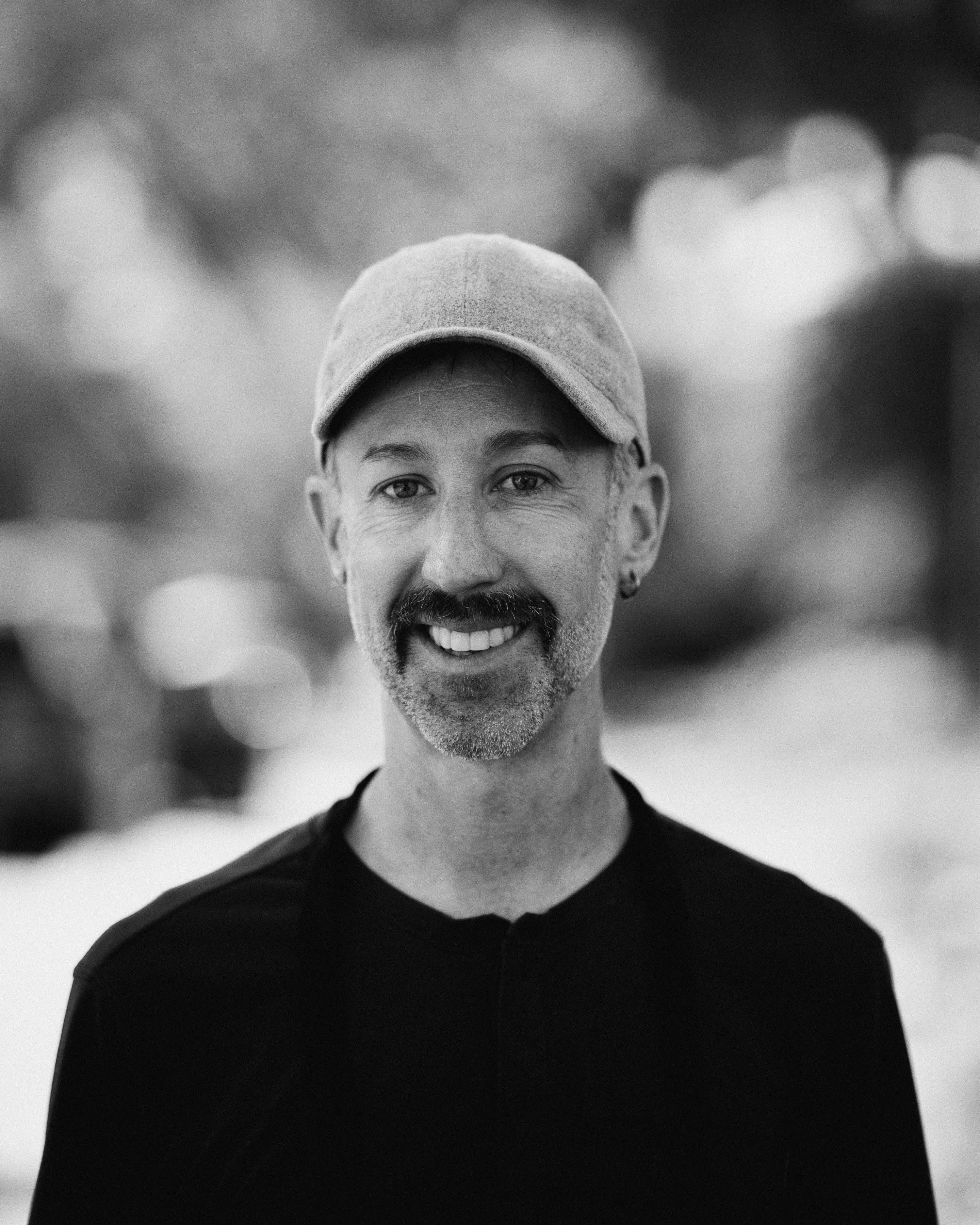 a man with a beard and mustache wearing a hat