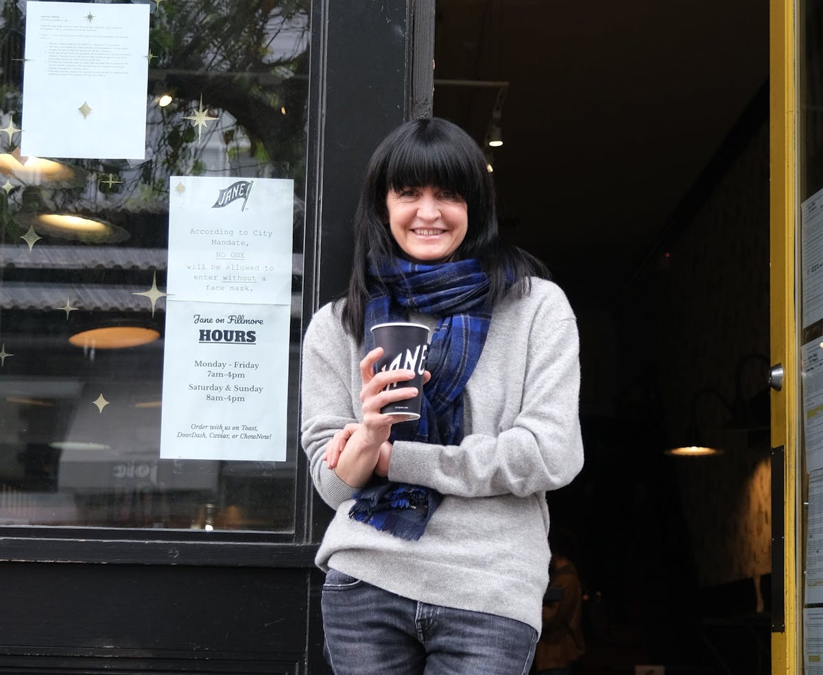 a woman holding a sign