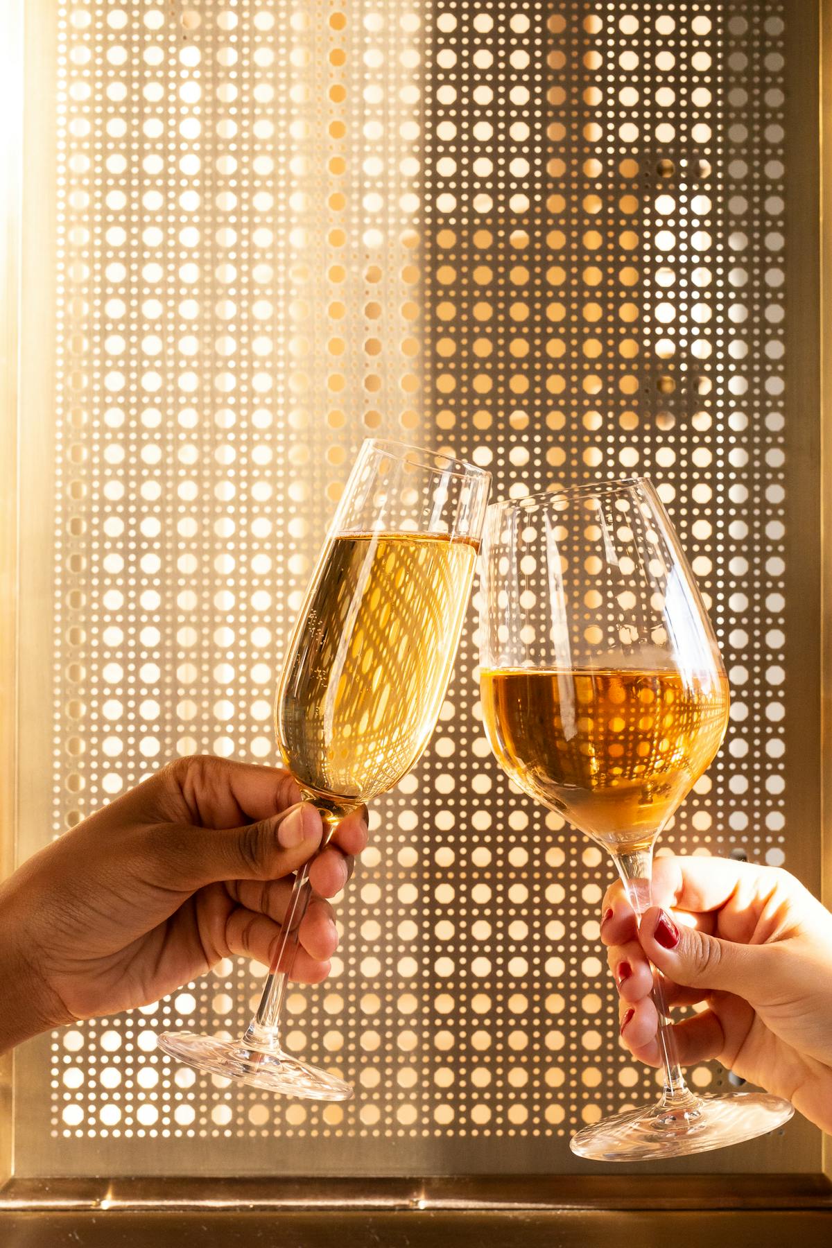 a hand holding a glass of wine