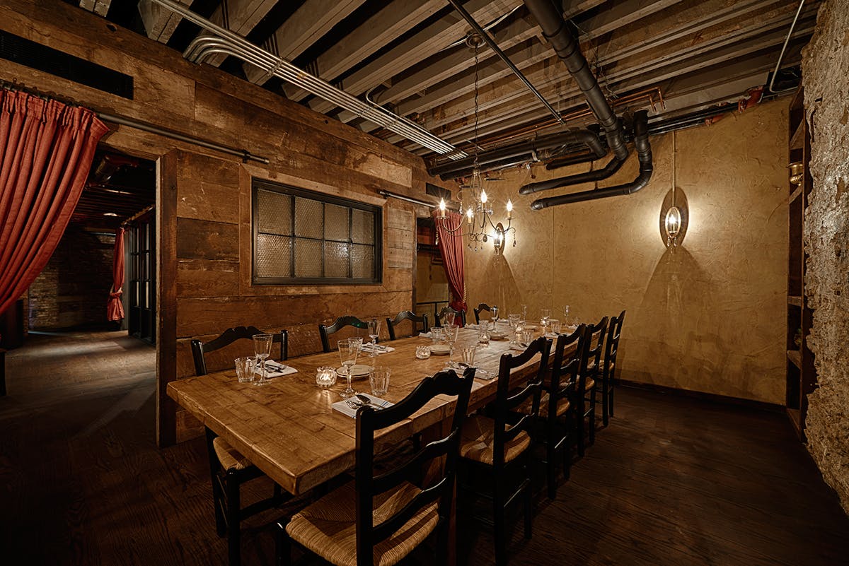 a room filled with furniture and a table in front of a building