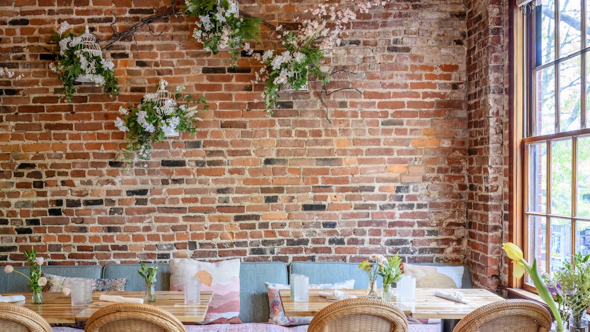 a fire place sitting in a chair in front of a brick building