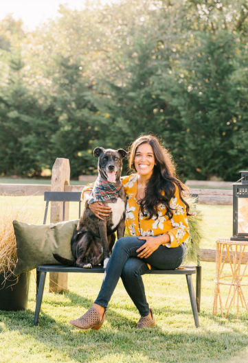 a woman sitting on a bench in a park