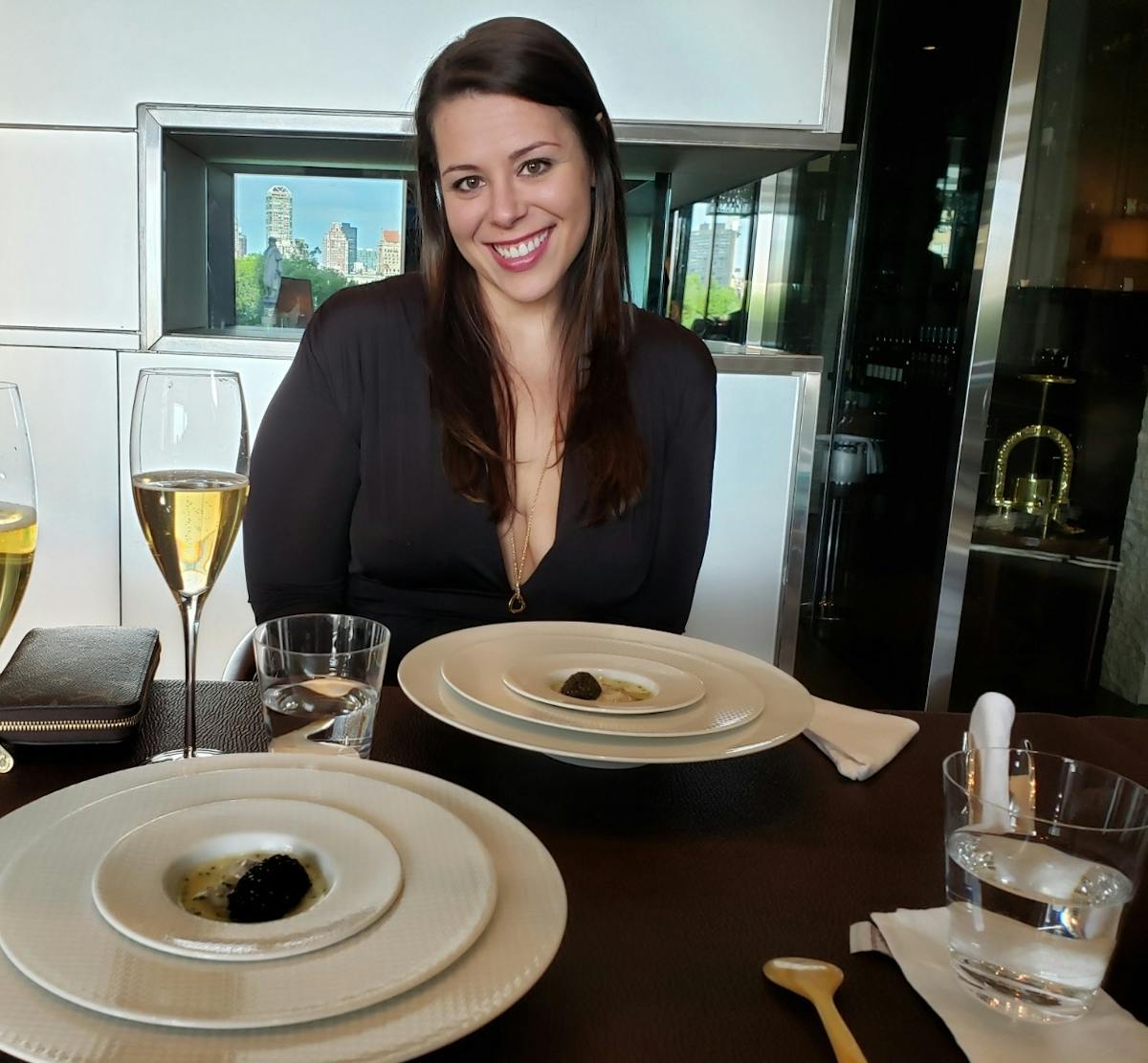 a person sitting at a table with a plate of food