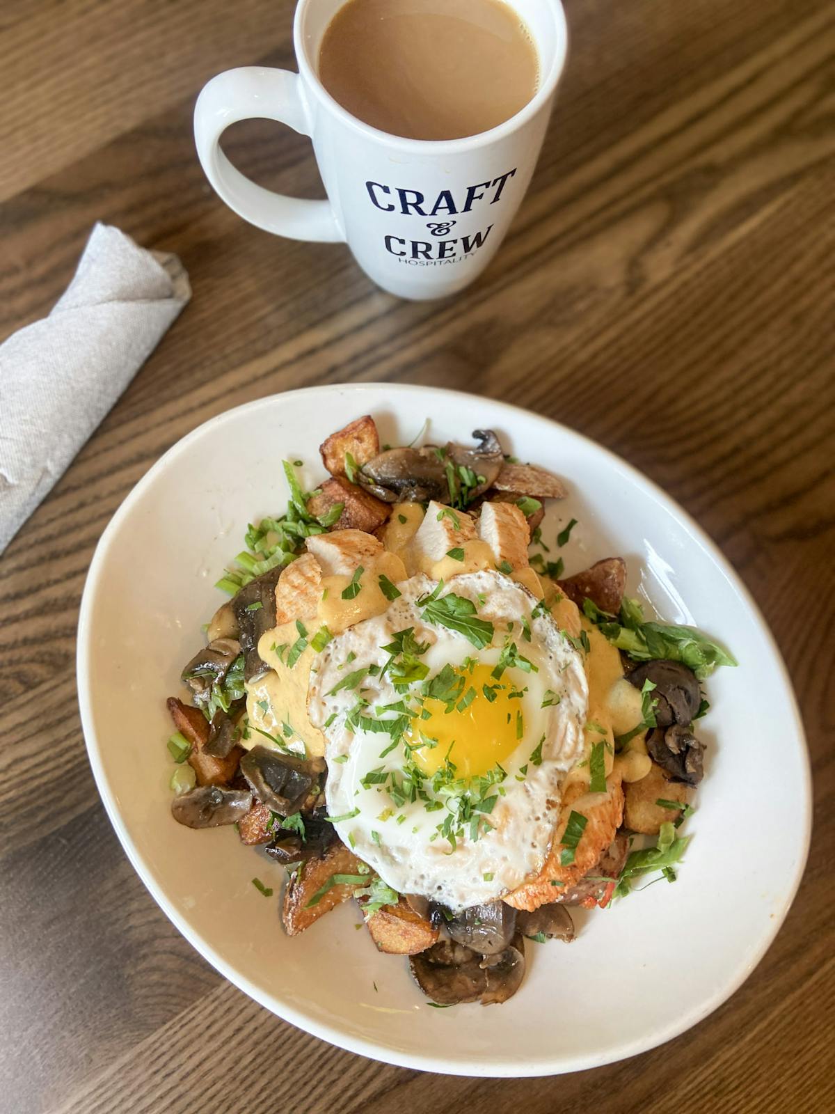a plate of Chicken Cholula Hash and a cup of coffee on a table