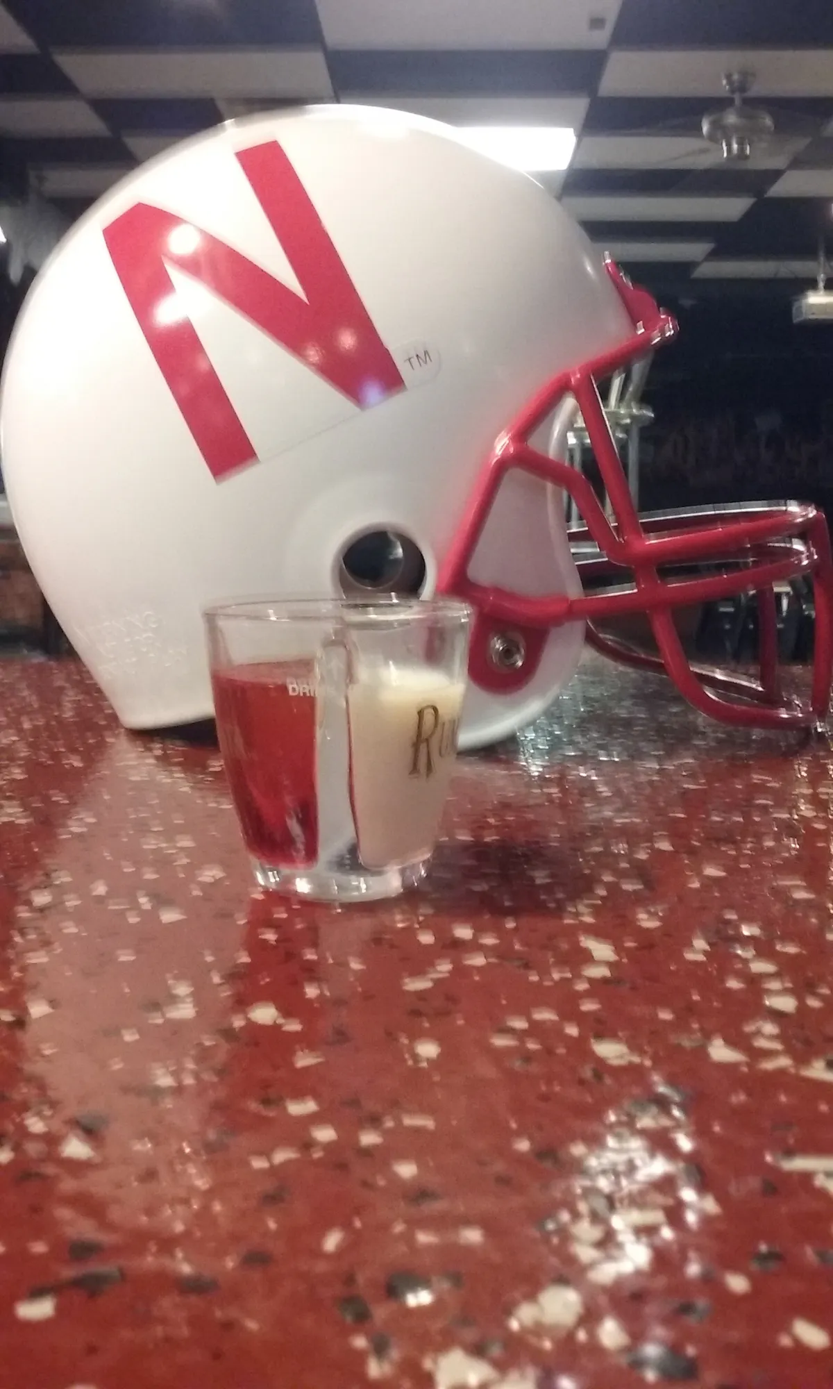 a cup with a helmet on a table