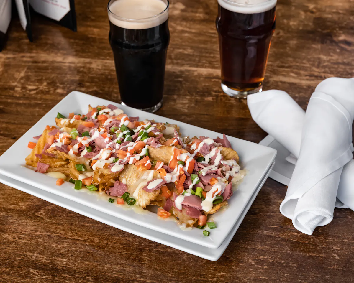 a plate of food and a glass of beer on a table