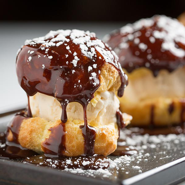 a piece of cake covered in chocolate sitting on top of a table