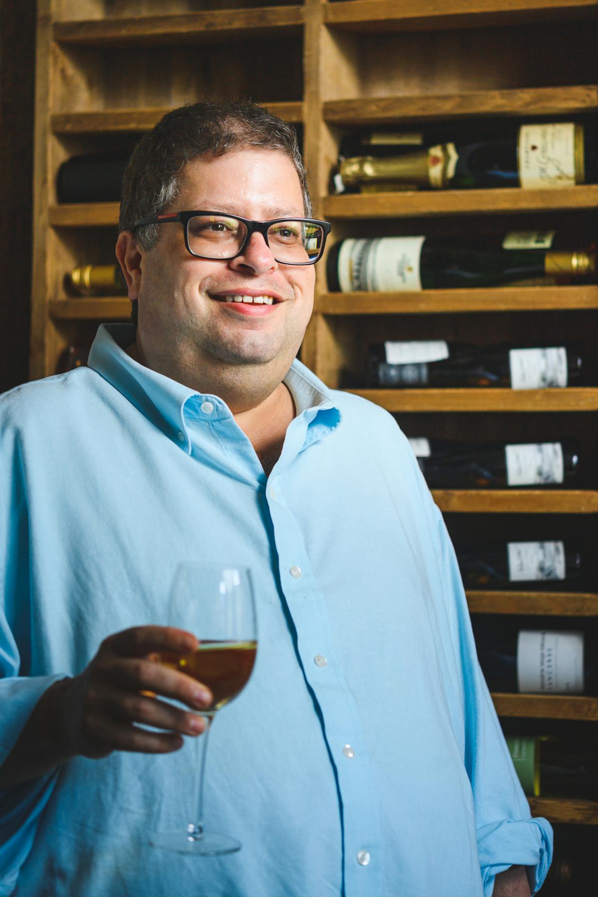 a man wearing glasses and a blue shirt