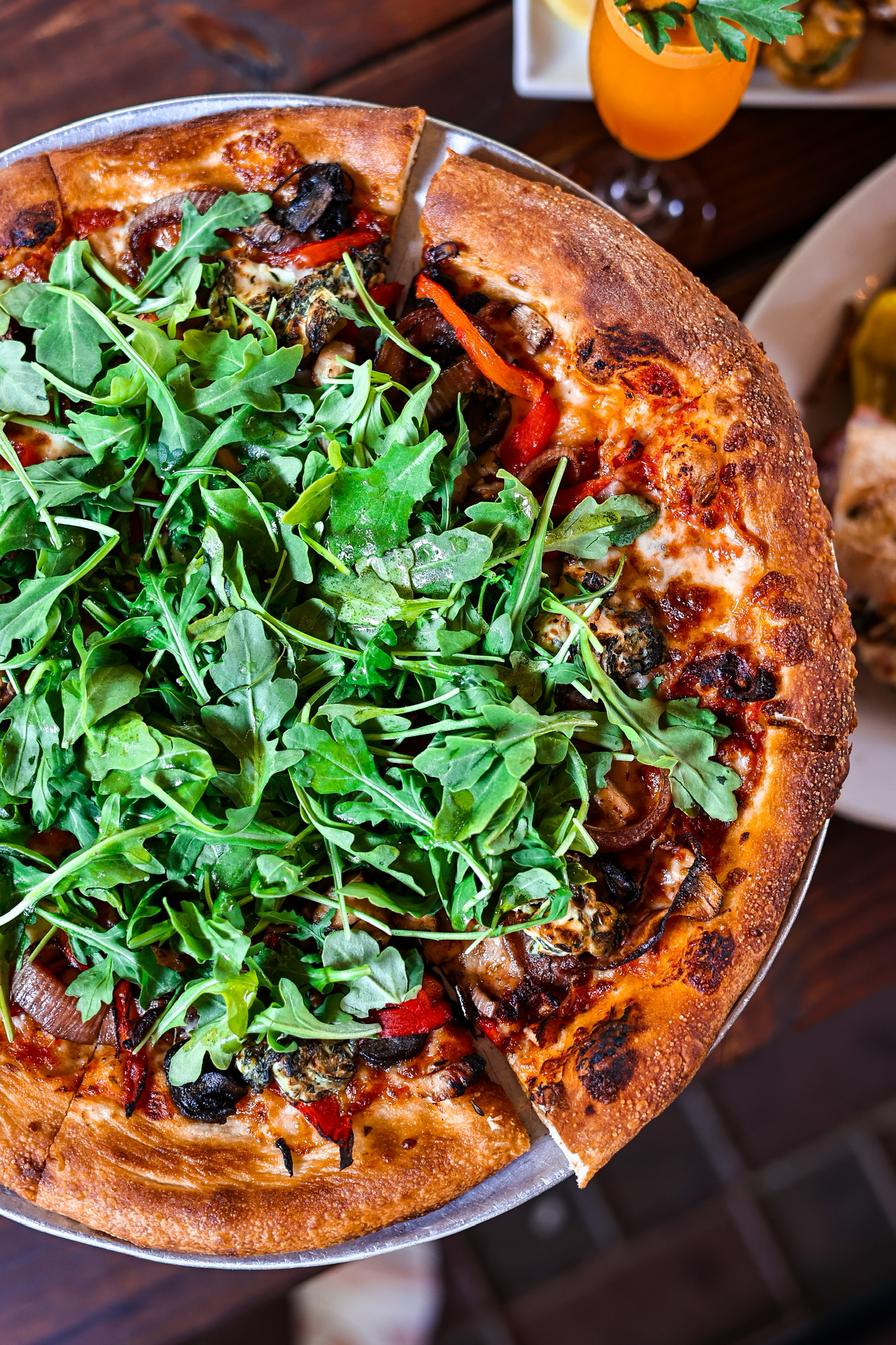 a pizza sitting on top of a plate of food