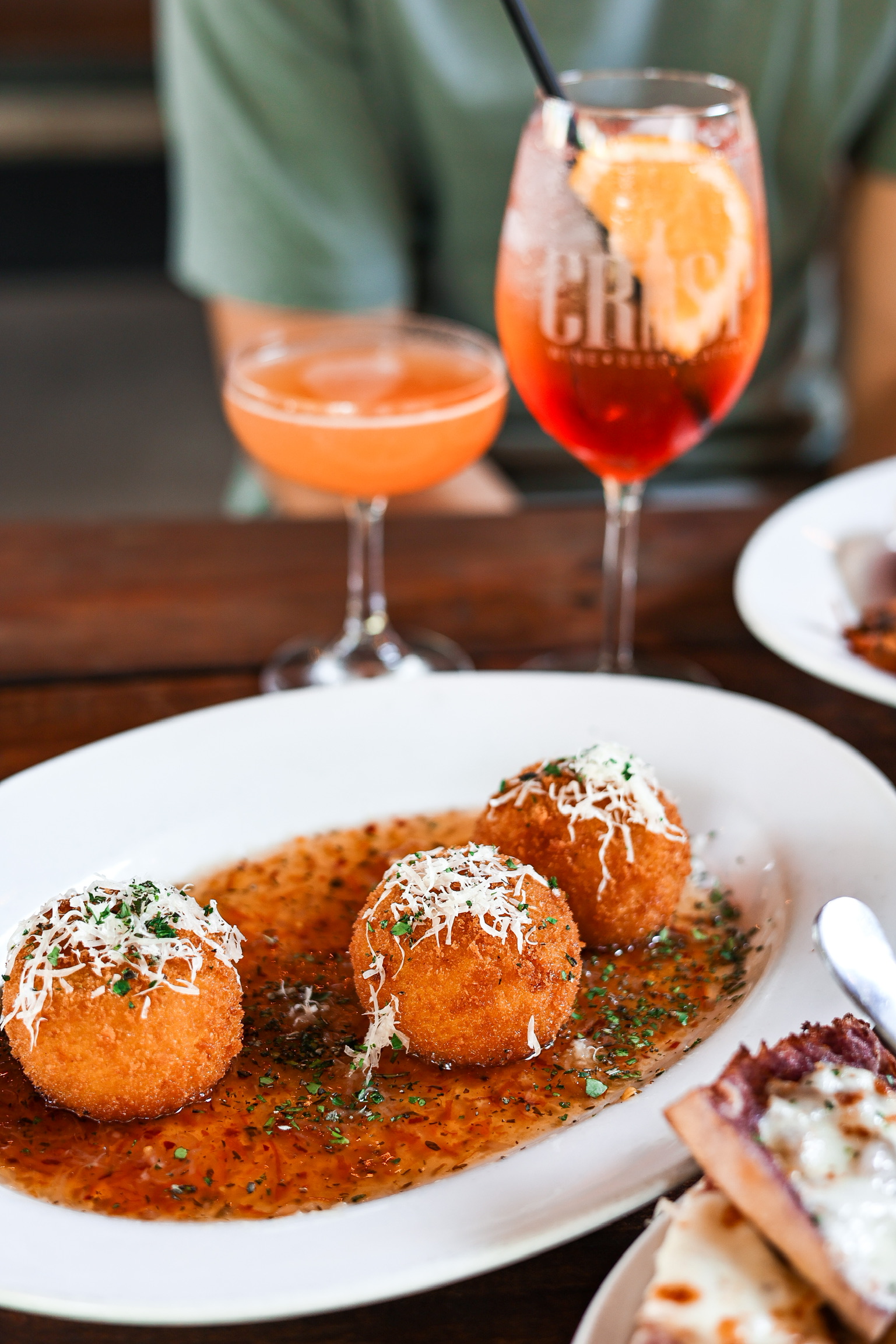 a plate of food and glasses of wine on a table