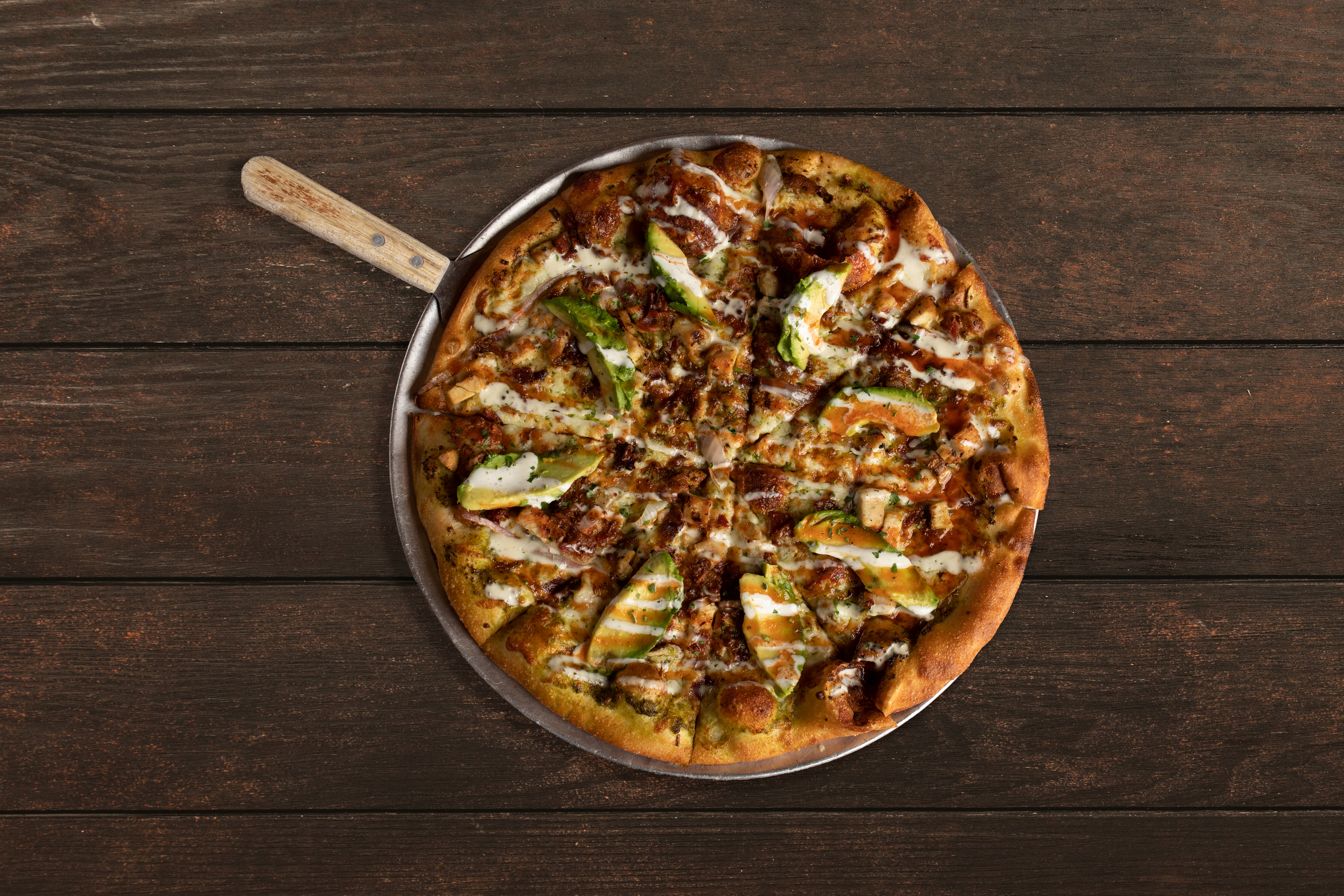 a pizza sitting on top of a wooden table