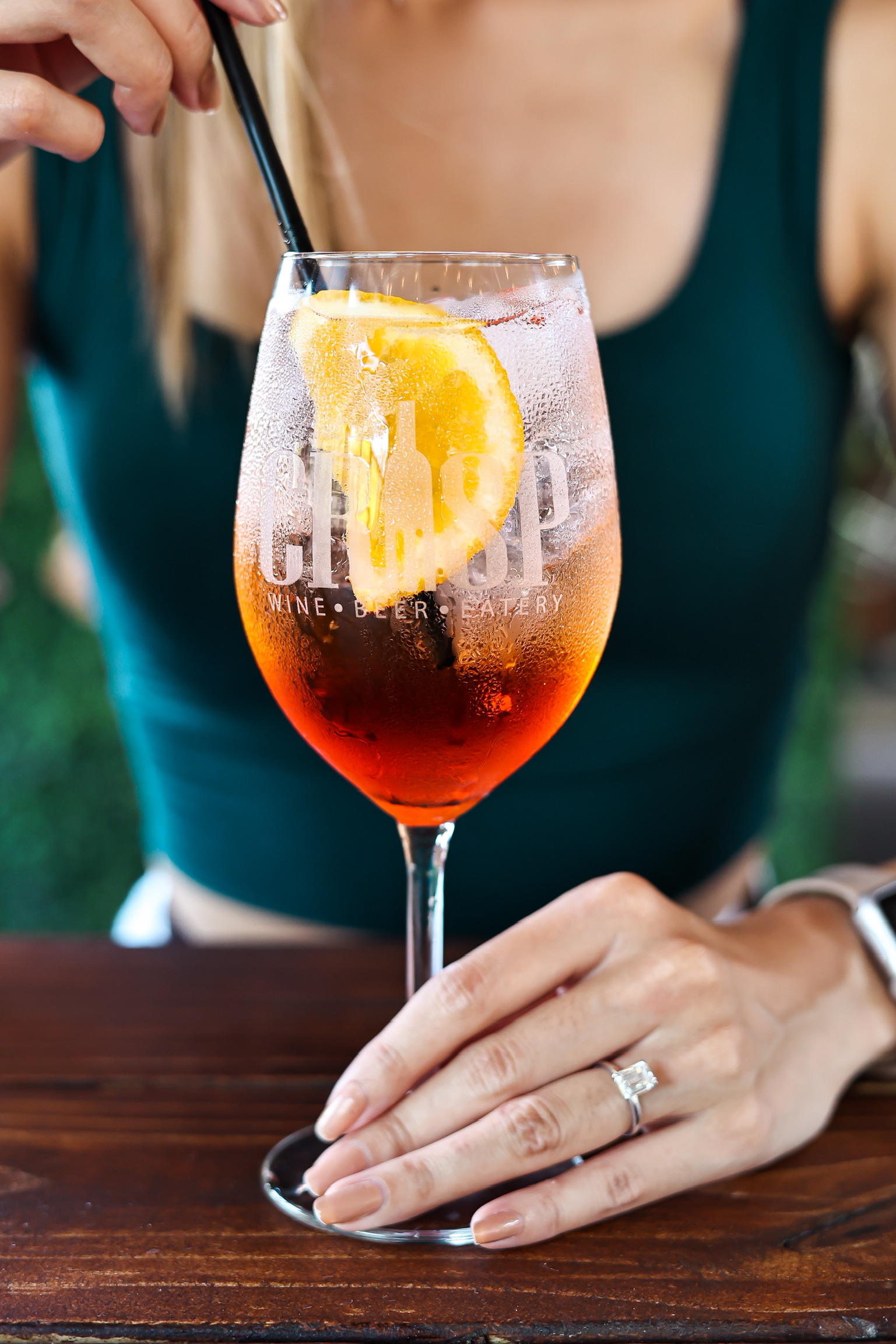 a close up of a person holding a wine glass