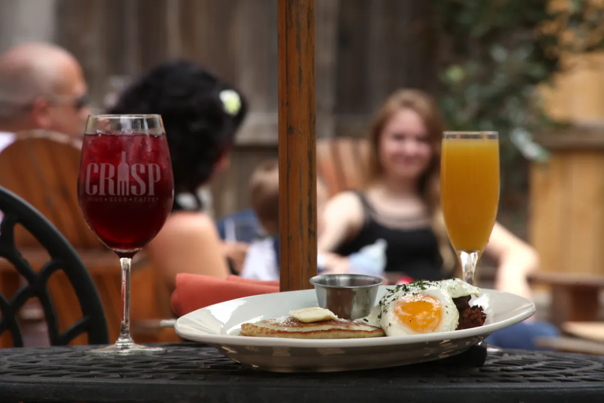 a person sitting at a table with a plate of food