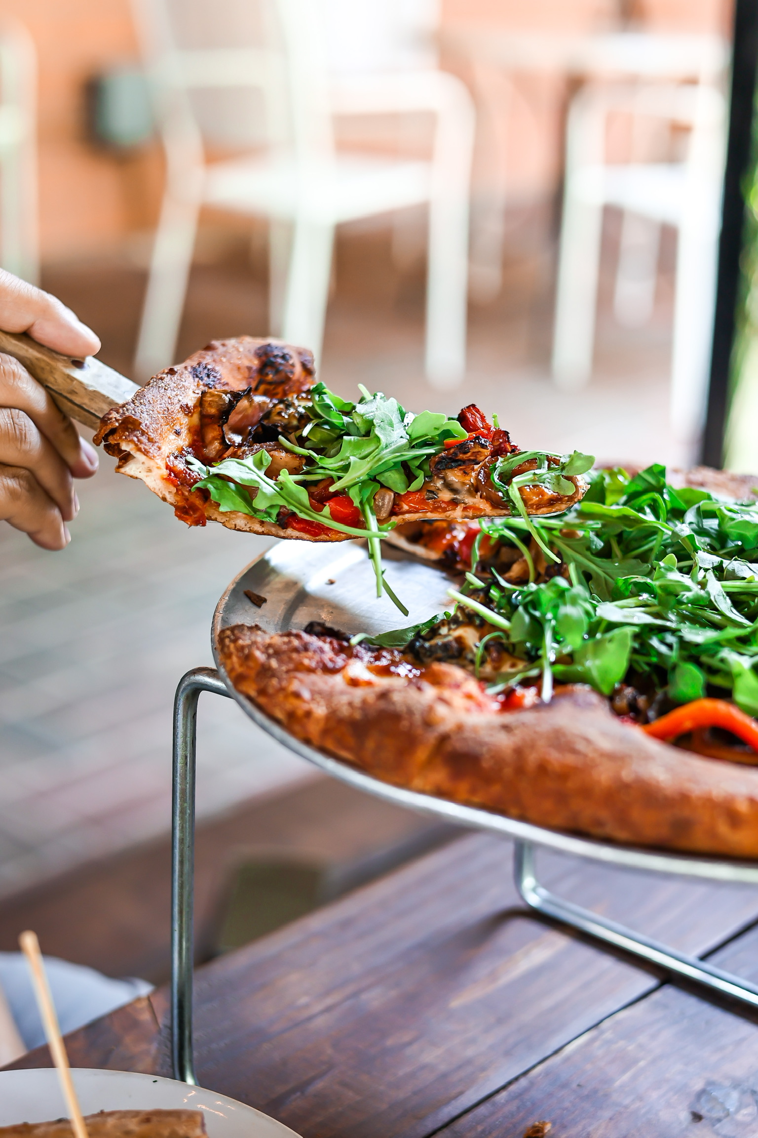 a pizza sitting on top of a wooden cutting board
