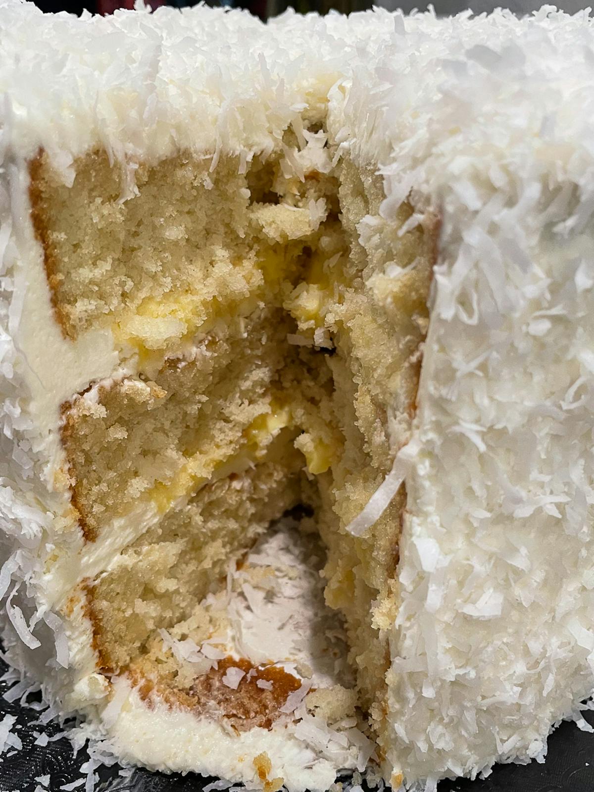 a close up of a piece of coconut cream cake