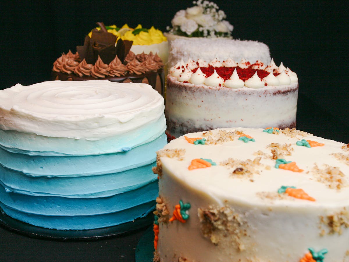 a display of multiple cakes at a bakery