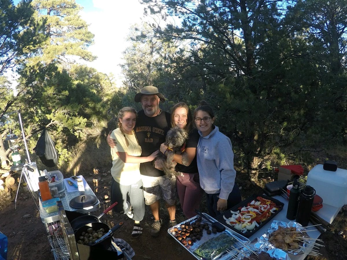 a group of people standing next to a tree