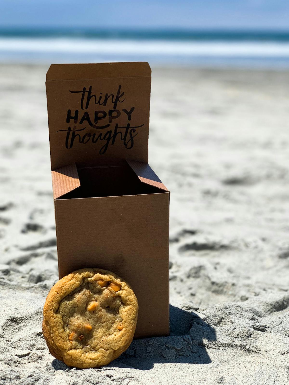 a box that has a sign on a beach