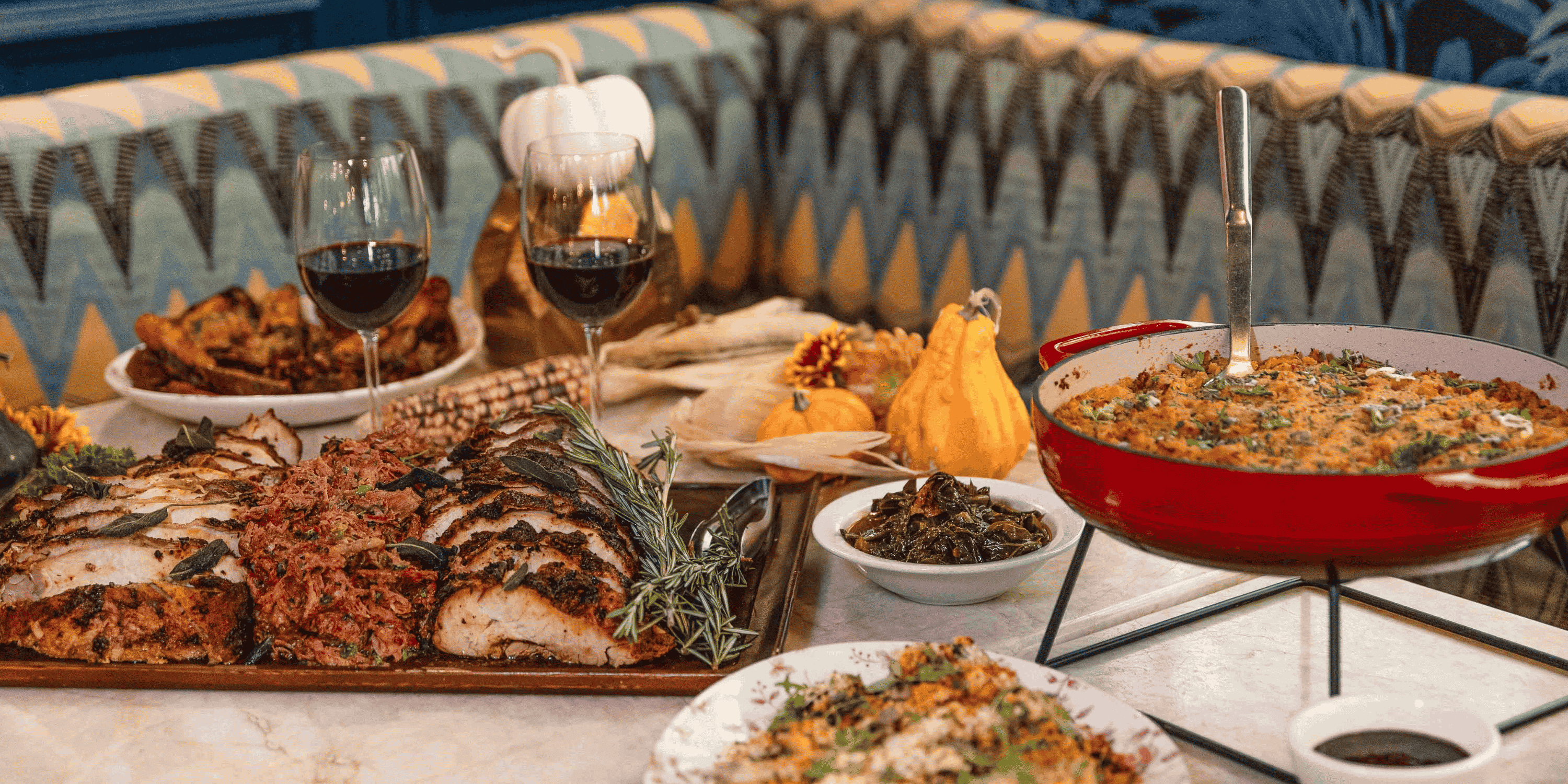 A variety of Thanksgiving food on a long table.