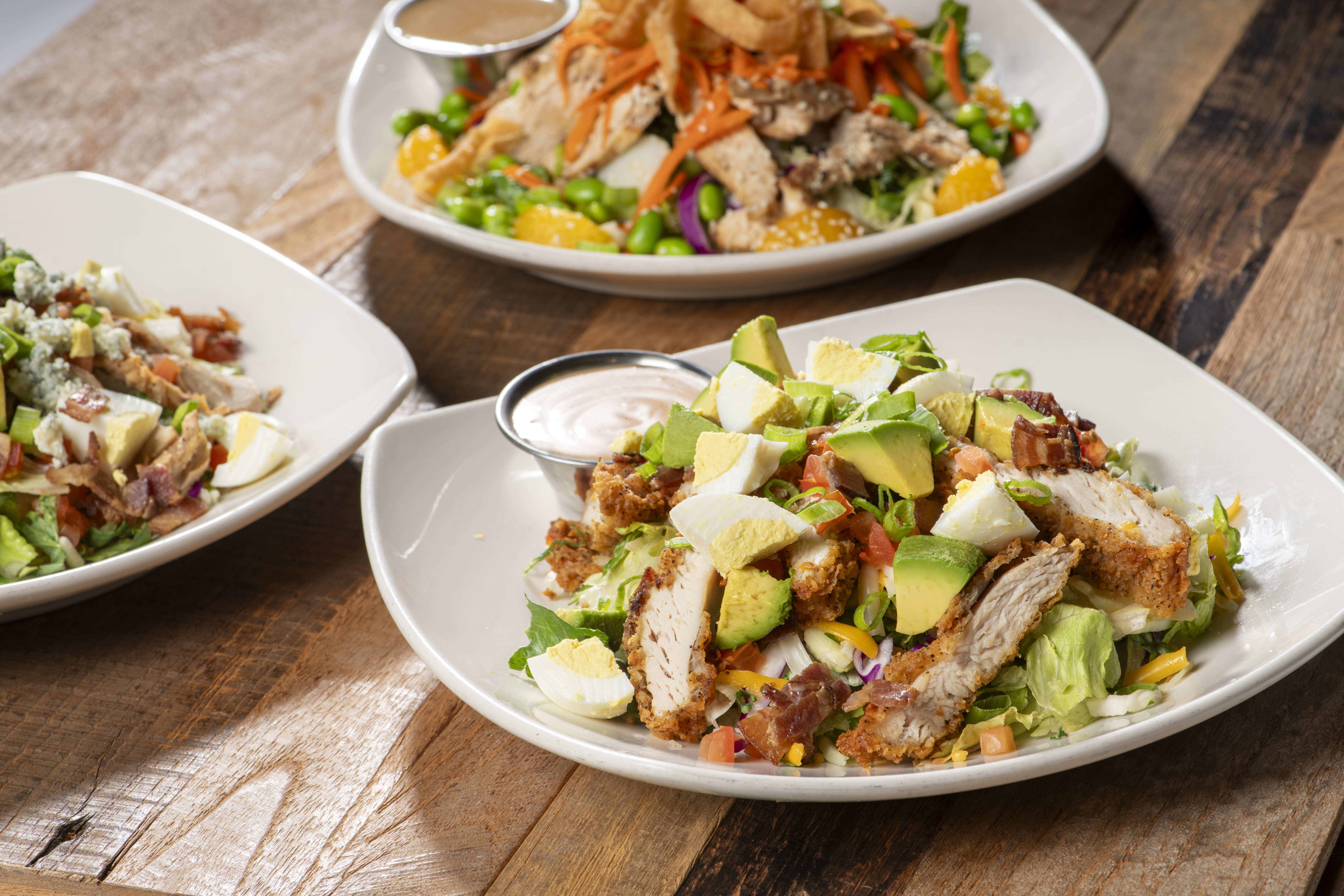 a bowl of salad on a plate on a table