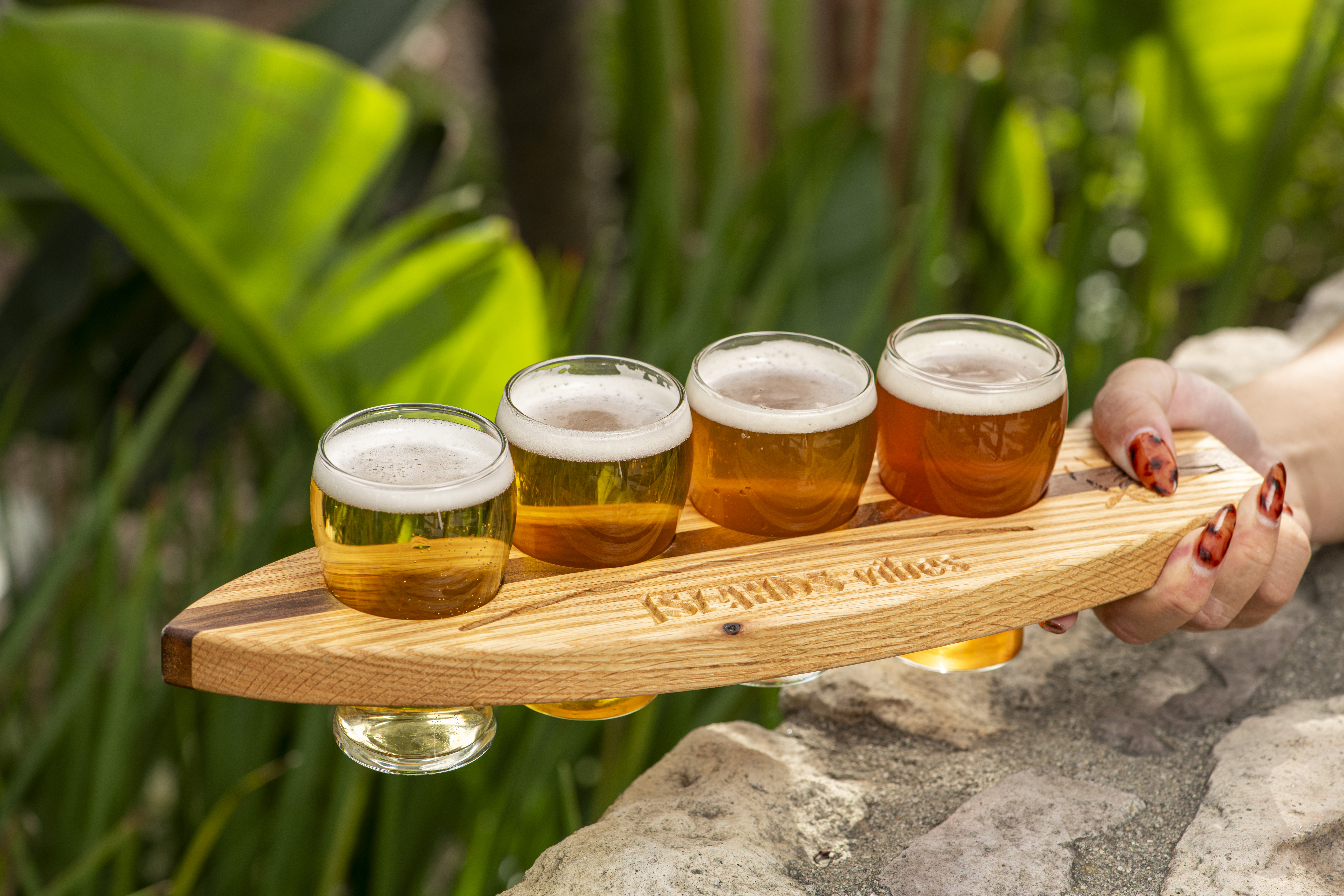 Beer Flight being held on a surfboard