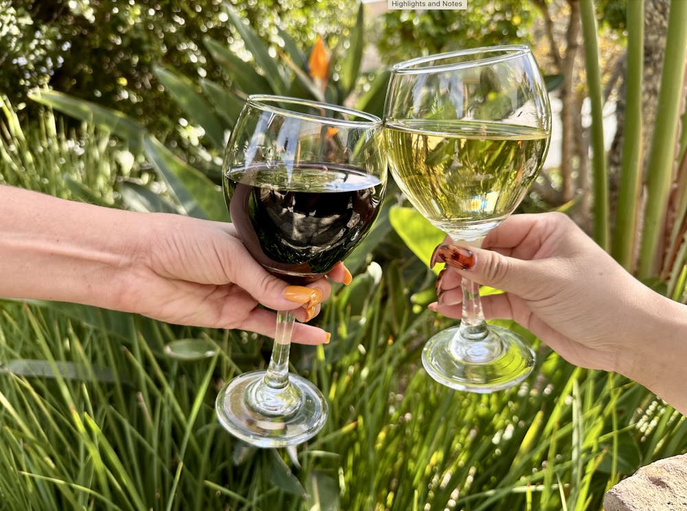 two glasses of wine cheering outside