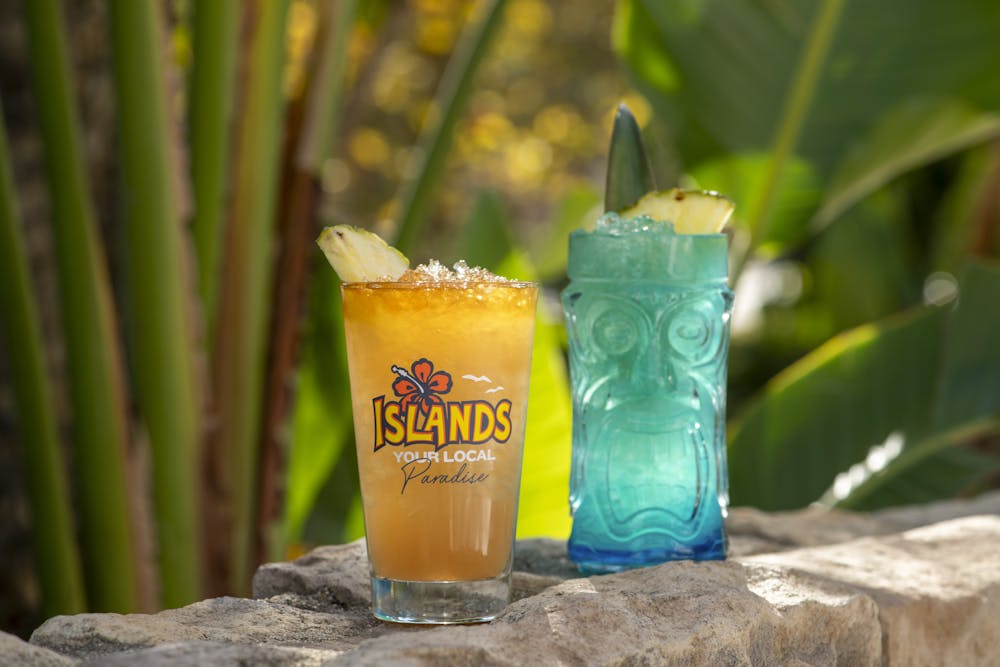 Mai Tai and Deep Blue Sea drink sitting on a rock