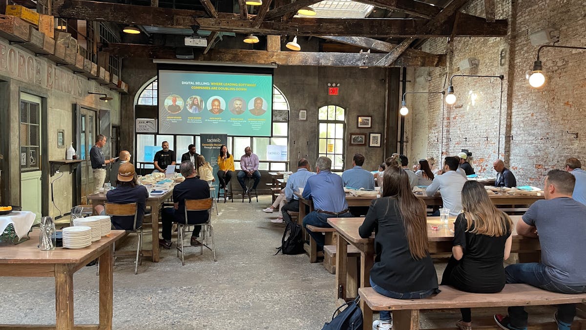 a conference with a screen and people sitting