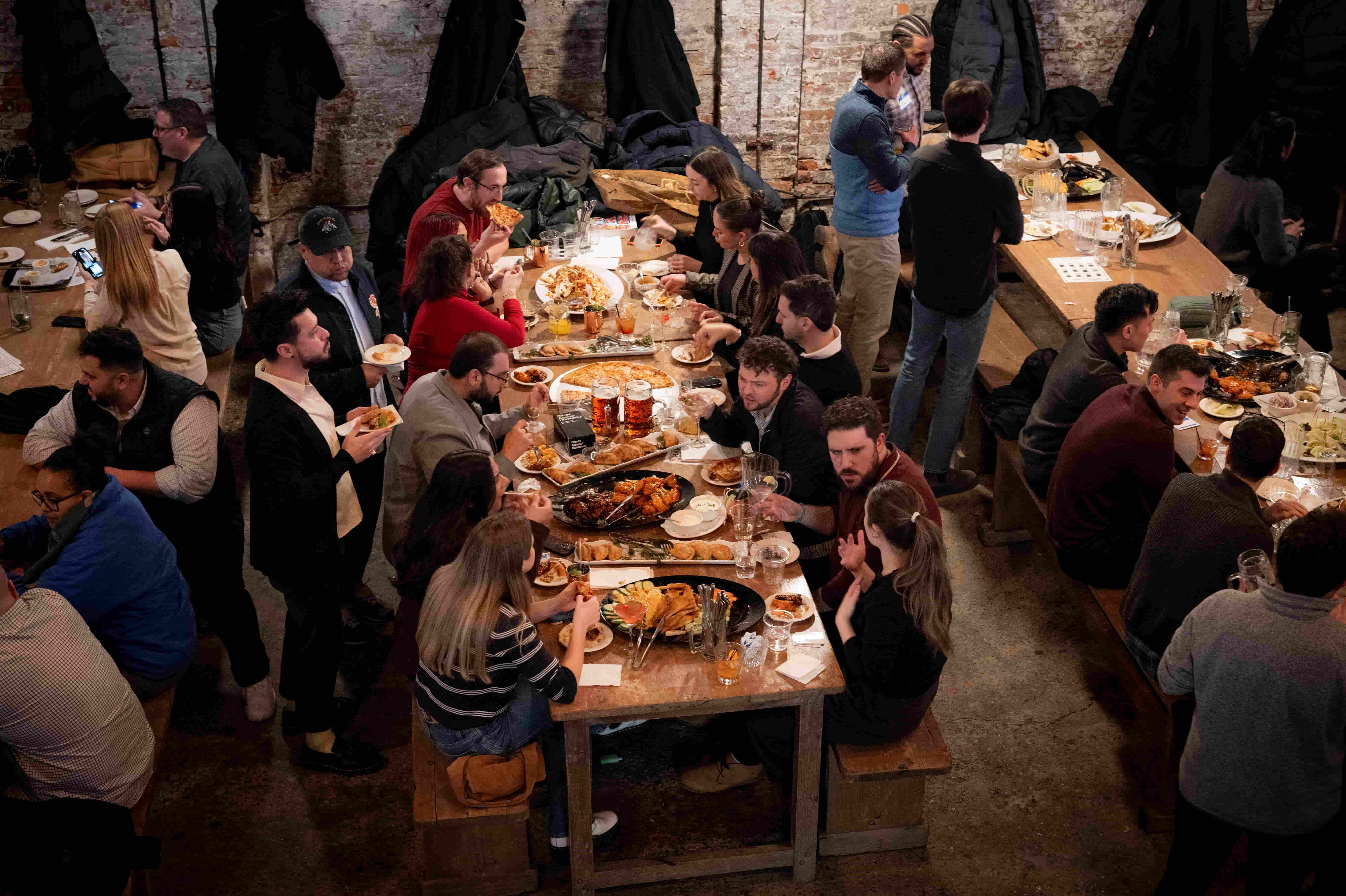a group of people around a table eating food