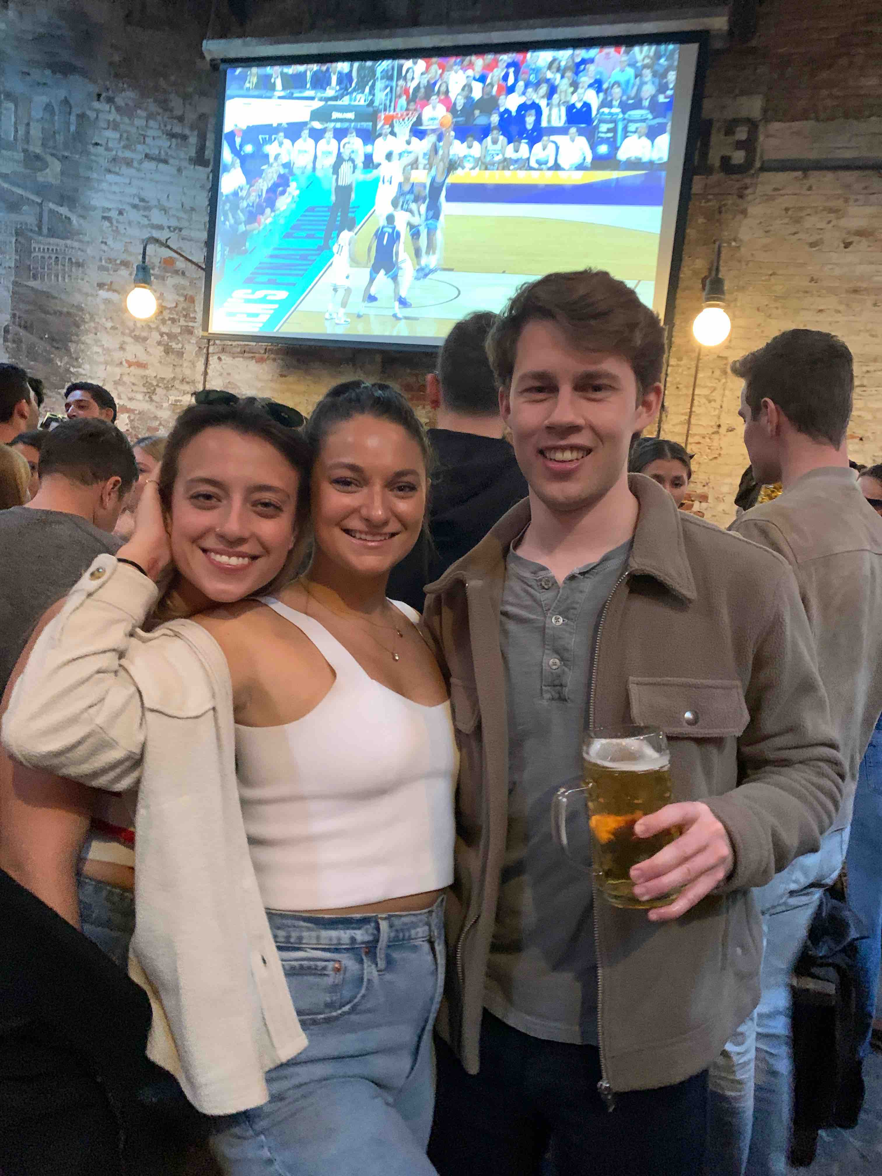 a group of people are drinking from a wine glass posing for the camera