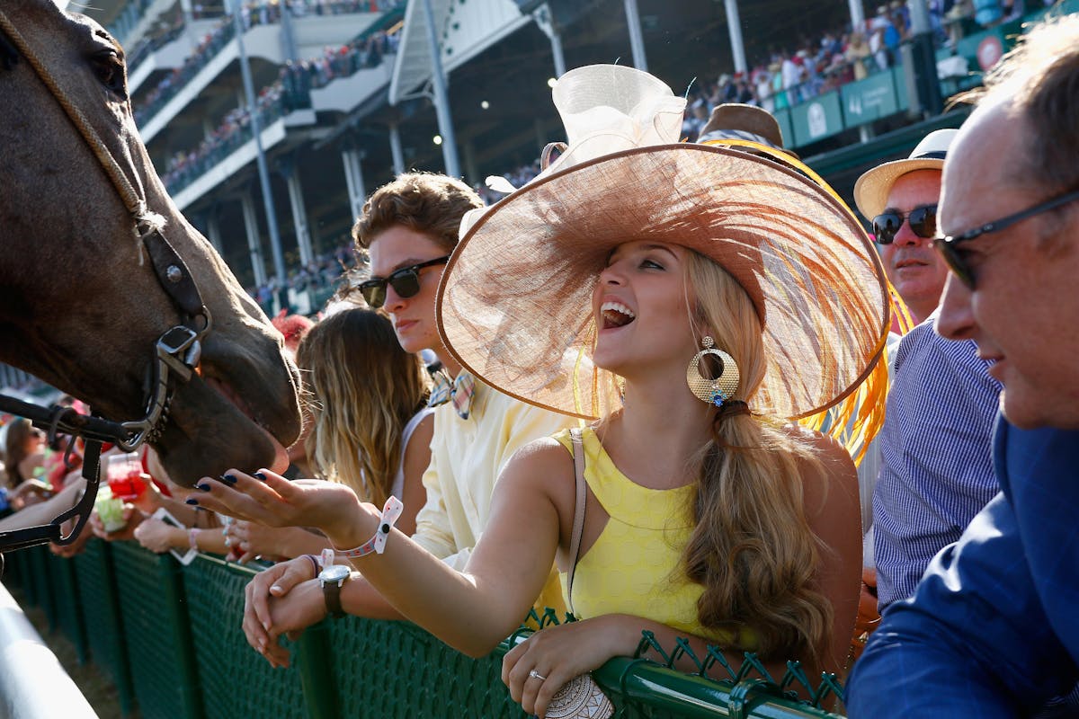 a woman at kentucky derby with a horse