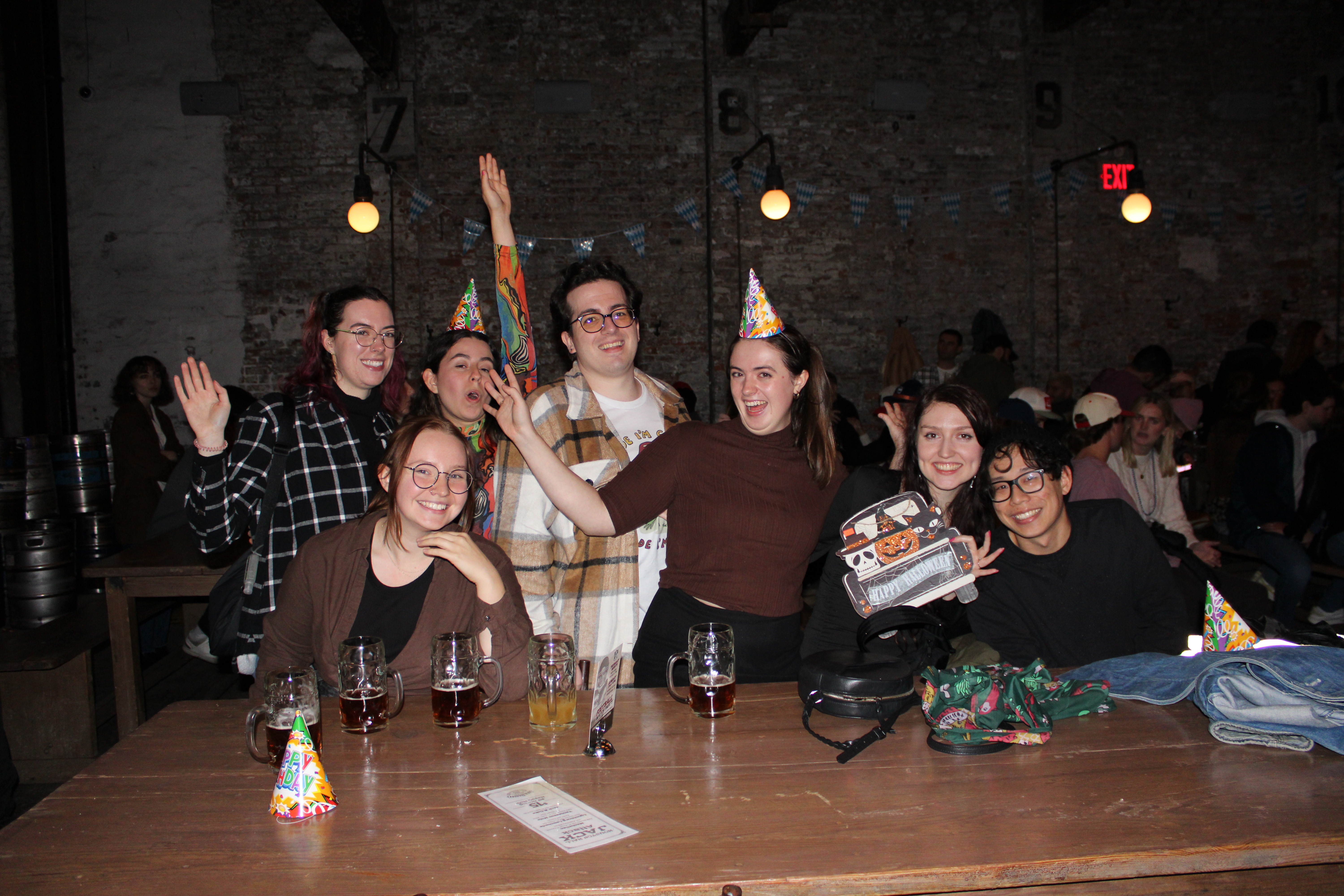 a group of people standing around a table