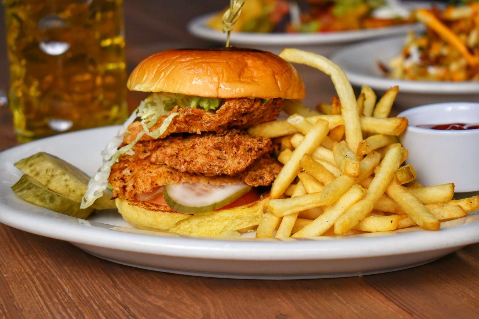 a close up of a sandwich and fries on a plate