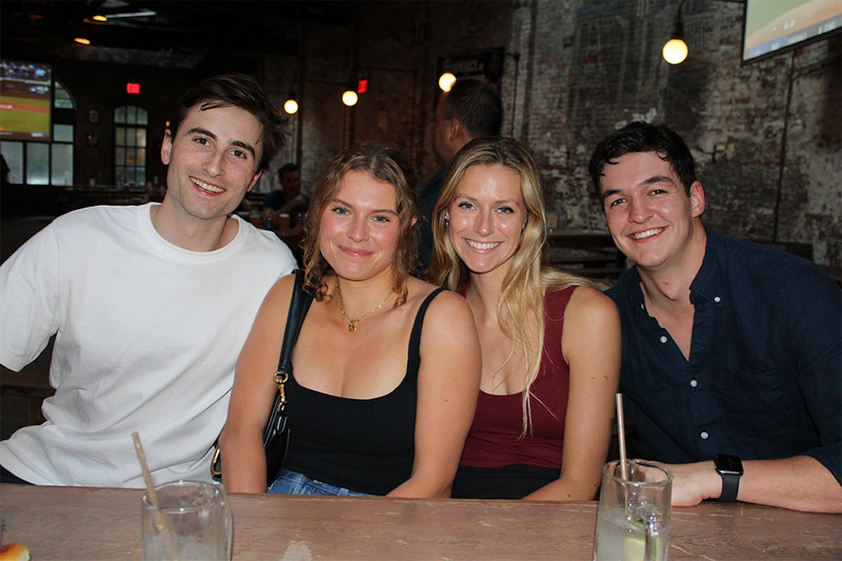 a group of people sitting at a table posing for the camera