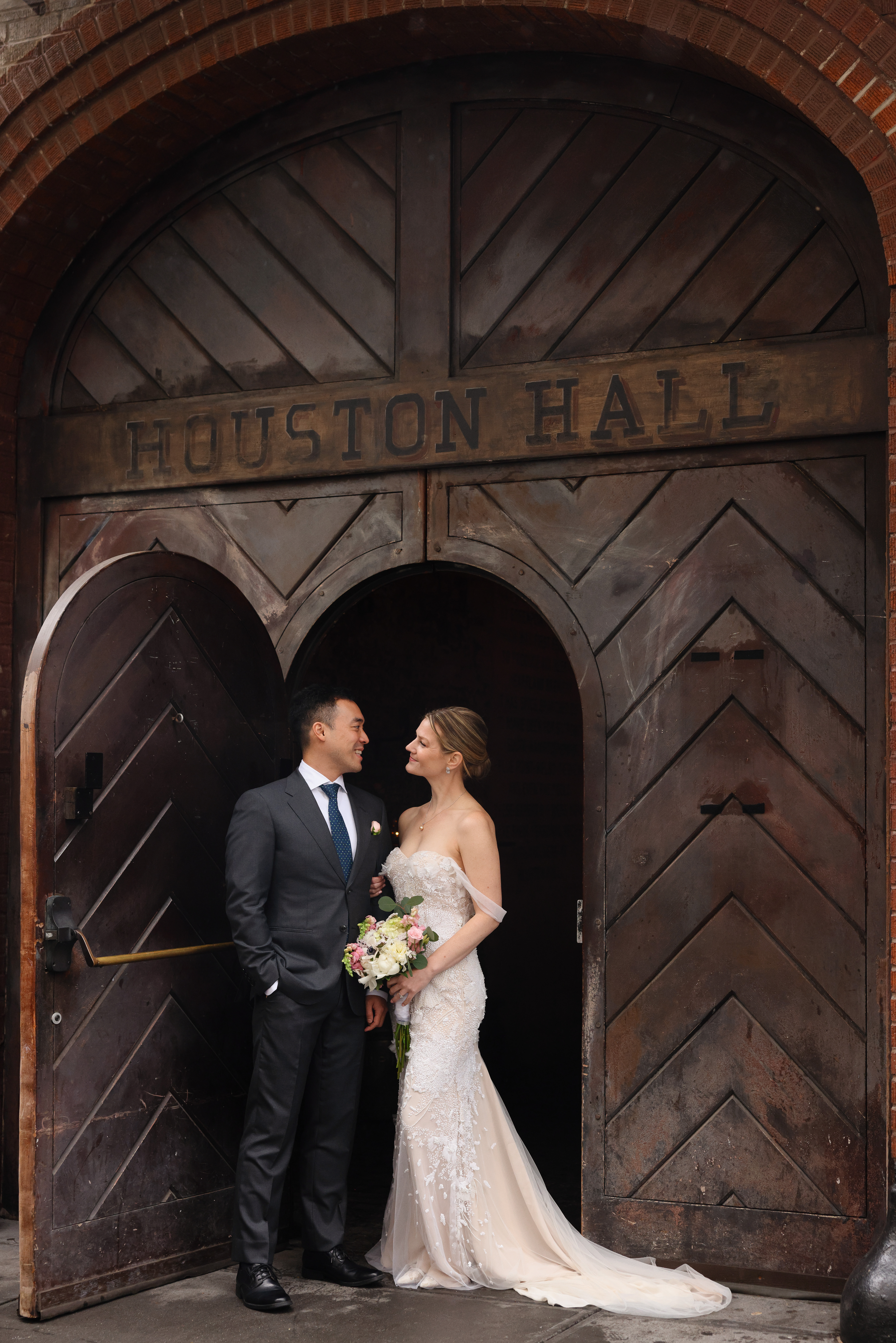 a man and woman standing in front of a door