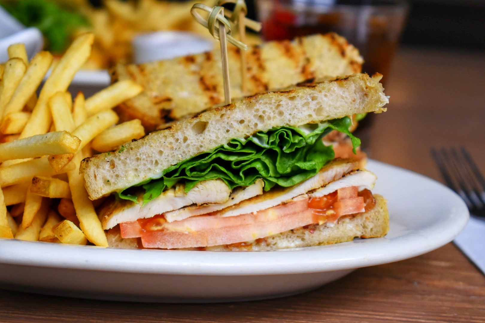 a close up of a sandwich and fries on a plate