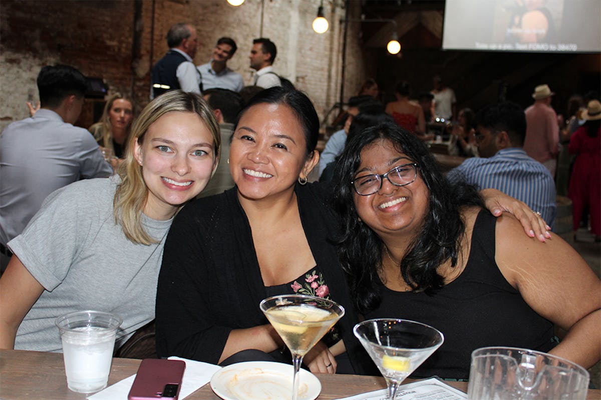a group of people sitting at a table in a restaurant